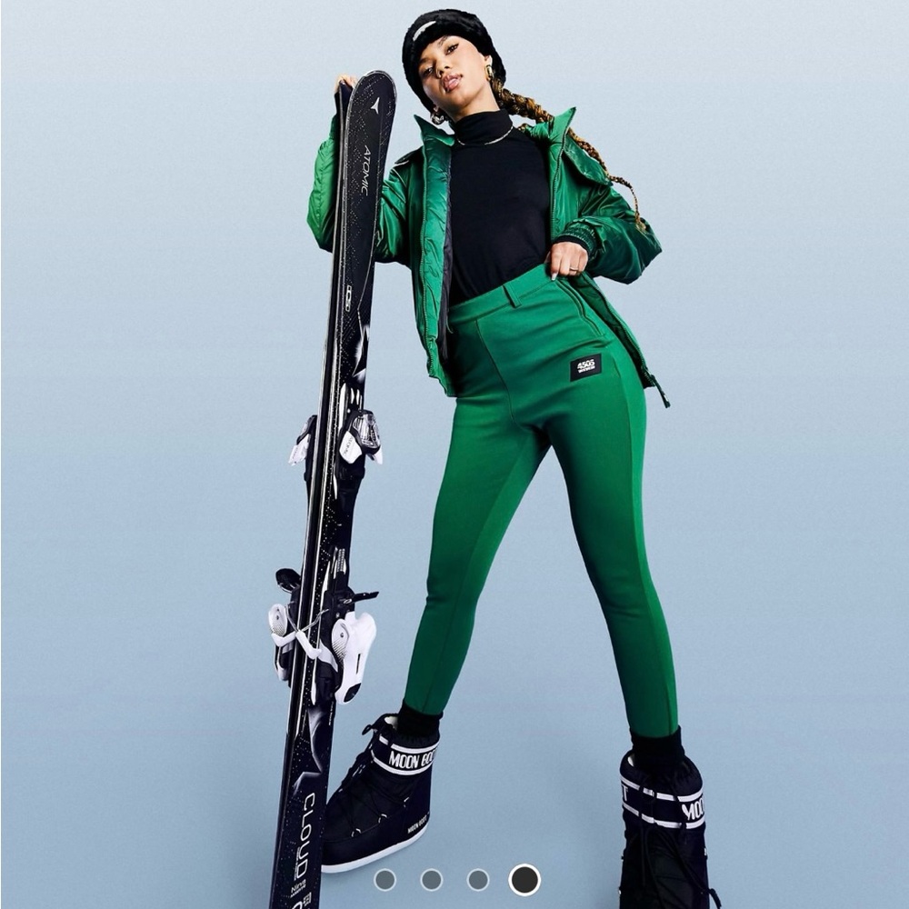 Stylish Green Ski Outfit with Snowboard